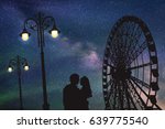 Lovers in amusement park at night. Vector illustration with silhouette of loving couple under starry sky. Vintage lampposts and Ferris wheel