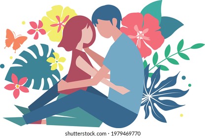 Lovers hugging each other against the backdrop of tropical plants