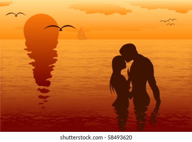 Lovers in the sea at romantic sunset