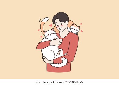 Loving animals and cat lover person concept. Young smiling loving man cartoon characters standing holding two big cats on hands hugging embracing vector illustration 