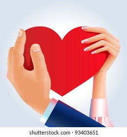 Loving couple holding red heart in their hands