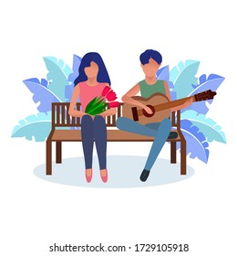 A loving guy plays the guitar for a girl with flowers. The concept of dedication of a song, declaration of love, communication, spending time together. Valentine's Day, March 8, birthday. 
