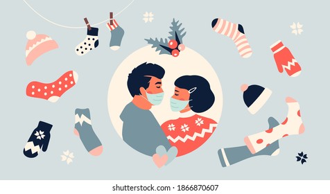 Loving kissing couple wearing protective face mask during coronavirus covid-19 pandemic. Christmas and New Year greeting card. Hygge and cozy nordic style. Warm socks, sweater, mittens, hat. 