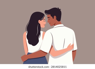 Loving young couple seen from the back with their arms around each other in a warm and romantic embrace at dusk.