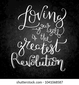 Loving yourself is the gratest revolution. Hand written calligraphy quote motivation for life and happiness on blackboard. For postcard, poster, prints, cards graphic design.