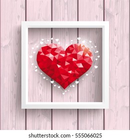 Low poly heart with frame on the wooden backround.. Eps 10 vector file.
