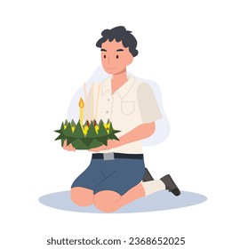 Festival Tradicional de Loy Krathong. Un estudiante tailandés se sienta y sostiene kratong y se prepara para llevar a Krathong a flotar en el río.