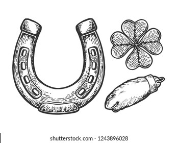 Luck talisman objects horseshoe clover rabbit paw engraving vector illustration. Scratch board style imitation. Black and white hand drawn image.