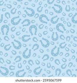 Lucky horseshoe. Blue silhouette. Seamless vector pattern. Endless ornament. Isolated blue background. St. Patricks Day. Flat style. Repeating symbol of happiness and good luck. Abstract image. 