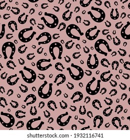 Lucky horseshoe silhouette. Seamless vector pattern. Endless ornament. Isolated pink background. Horse shoes. Ink drawing imitation. St. Patricks Day. Flat style. Idea for web design, cover, textile. 