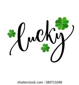 Lucky word - St. Patrick's day lettering for t-shirts and cards. Brush calligraphy design with shamrock.