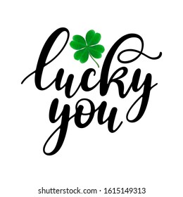 Lucky you - black handwritten lettering with four-leaf shamrock isolated on white background. 17 March St. Patrick's, Valentine's Day artwork. Good for greeting cards, t-shirt, and mug design.