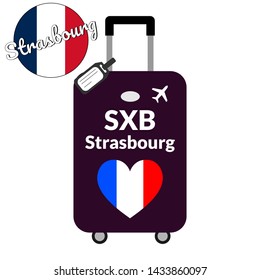 Luggage with airport station code IATA or location identifier and destination city name Strasbourg, SXB. Travel to France, Europe concept. Heart shaped flag of the France on baggage