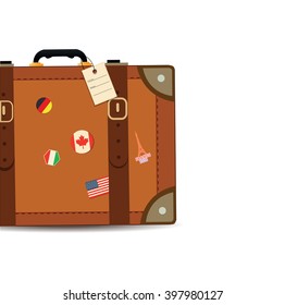 Luggage with traveling stickers at the beach. Summer theme.