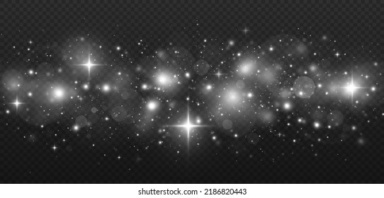 El polvo luminoso se tambalea sobre un fondo transparente. Las chispas blancas y las estrellas brillan con un efecto luminoso especial.