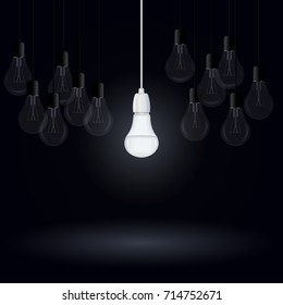 Luminous energy saving lamp among incandescent light bulbs on a dark background, vector illustration