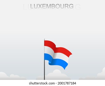 The Luxembourg flag flutters on a pole that stands tall under a white sky