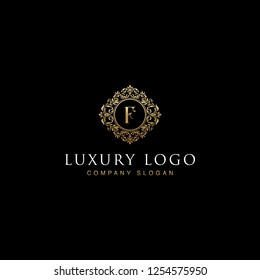 Luxurious elegant victorian floral filigree frame badge pattern with Initial letters F inside  circle badge emblem logo design vector in gold colors