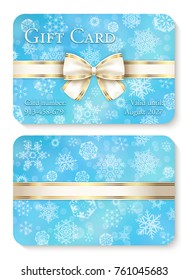 Luxury baby blue Christmas gift card with white snowflakes in background and cream ribbon as decoration