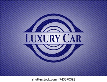 Luxury Car badge with denim background