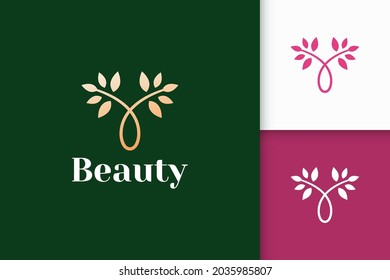 Luxury flower logo from combination of plant and pot for beauty care