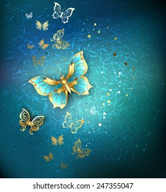 Luxury gold butterflies on blue textural background. 