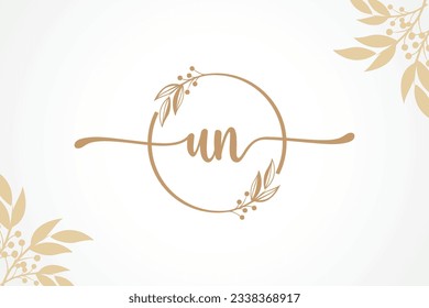 luxury gold signature initial un logo design isolated leaf and flower