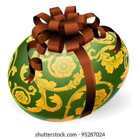 A luxury green Easter egg with ornate gold pattern and brown bow