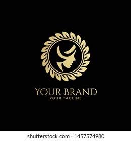 luxury logo template of woman's face isolated in round leaf badge in gold color