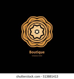 Luxury logotype in the shape of a flower for antique boutique. Gold logo, flower on black background. Simple geometric sign. Icons, business, invitations. Volumetric golden big bud. Vintage. Retro.