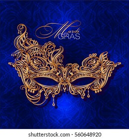 Luxury ornate golden carnival mask Mardi Gras on a blue background. Vector illustration.