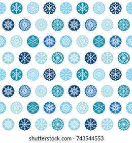 Luxury vector seamless pattern design with snowflake ornaments in round scalloped shapes in blue and white