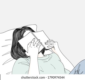   Woman lying in bed reading a book