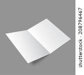 Lying  blank two fold paper brochure on gray background. Open magazine. Cover for your design