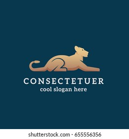 Lying Golden Lion Abstract Vector Sign, Emblem or Logo Template. Flat Style Graceful Lioness Silhouette with Typography on Dark Background.