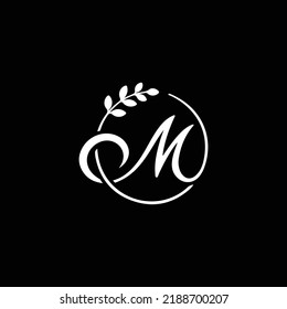 M Letter with leaf logo. Vector logo template letter m decorated with leaves