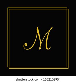 m letter logo design in black background.m letter golden color.