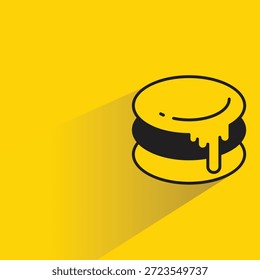 Macaron-Symbol auf schattengelbem Hintergrund