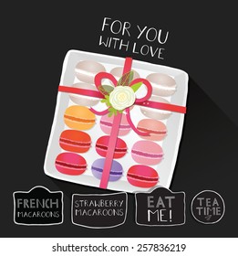 Macaroons in a gift box, on chalkboard with handwriting labels.