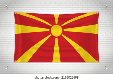 Macedonia flag hanging on brick wall. 3D drawing. Flag attached to the wall. Neatly drawing in groups on separate layers for easy editing.