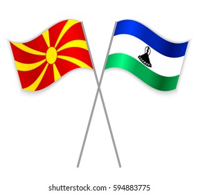 Macedonian and Basotho crossed flags. Macedonia combined with Lesotho isolated on white. Language learning, international business or travel concept.