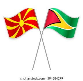 Macedonian and Guyanese crossed flags. Macedonia combined with Guyana isolated on white. Language learning, international business or travel concept.