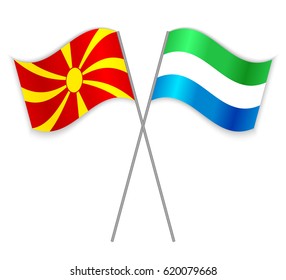 Macedonian and Sierra Leonean crossed flags. Macedonia combined with Sierra Leone isolated on white. Language learning, international business or travel concept.