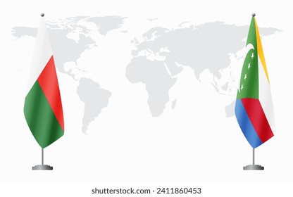 Madagascar and Comoros flags for official meeting against background of world map.