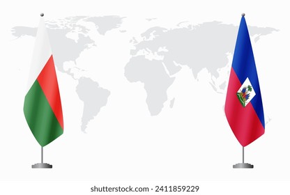 Madagascar and Haiti flags for official meeting against background of world map.