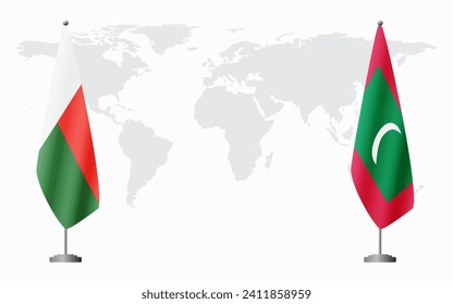 Madagascar and Maldives flags for official meeting against background of world map.
