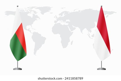 Madagascar and Monaco flags for official meeting against background of world map.