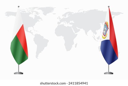 Madagascar and Sint Maarten flags for official meeting against background of world map.