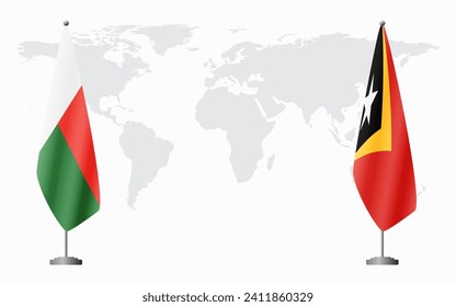 Madagascar and Timor-Leste flags for official meeting against background of world map.