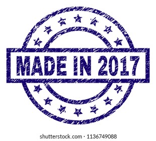 MADE IN 2017 stamp seal watermark with grunge texture. Designed with rectangle, circles and stars. Blue vector rubber print of MADE IN 2017 tag with unclean texture.